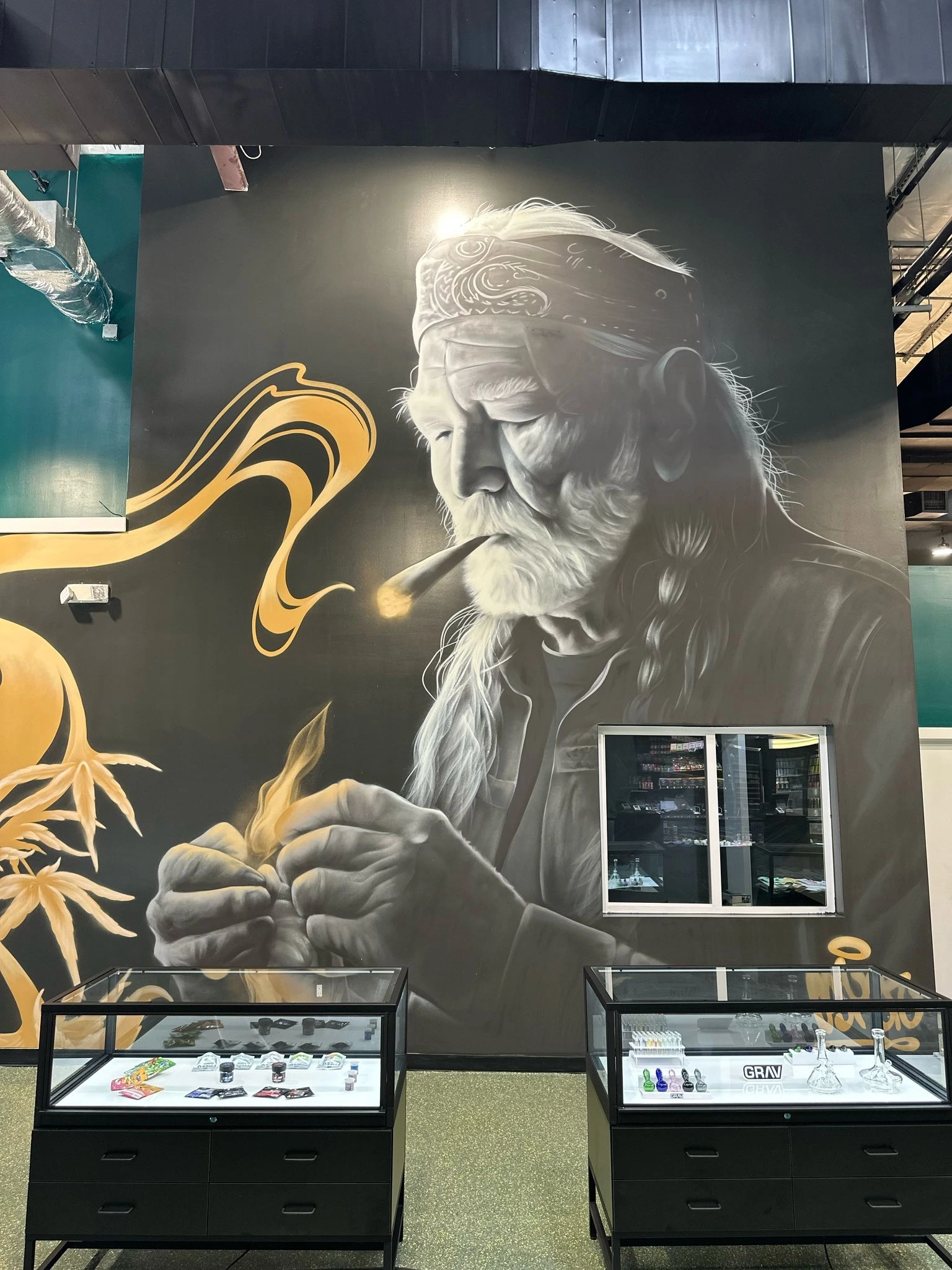 Mural and display cases inside the St. Elmo store of THC Dispensary Austin Lounge